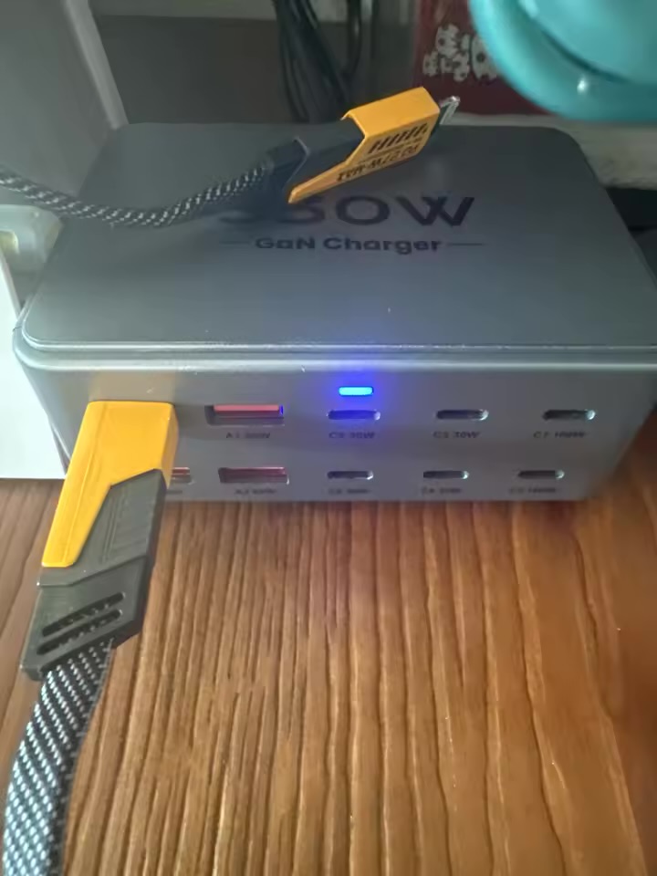 Charging station with two thick right-angle USB-C cables plugged in